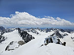 Looking south from the summit at the tracks in the snow and the main spine of the range.